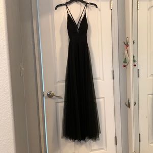 Black Long prom/ formal dress. 2 slits on the front, low cut top.
